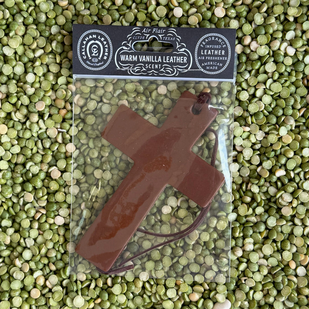 Callahan Leather Cross Air Freshener in Brown, handcrafted from full-grain vegetable-tanned leather for durability, infused with a warm vanilla leather fragrance for a soothing aroma, with a sturdy leather cord for easy hanging - AFCROSSBRWVL. Available at Blair's Western Wear, Marble Falls, TX.