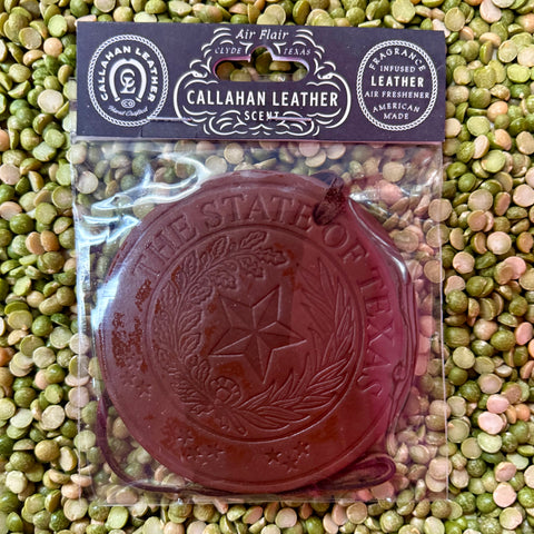 Callahan Leather round leather air freshener in brown, infused with a warm authentic leather scent, with durable genuine leather construction – AFRSEALBRWLTH. Available at Blair's Western Wear, Marble Falls, TX.