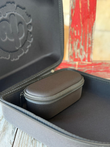 The Cactus Ally Hat Company Cap Carrier keeps your favorite caps protected and organized on the go. Designed in sleek black, it holds 4–5 caps securely and includes a built-in sunglasses case for added convenience. Carry it your way with both handheld and shoulder strap options—perfect for travel, rodeos, or everyday use. Available at BLAIR'S Western Wear located in Marble Falls, TX 