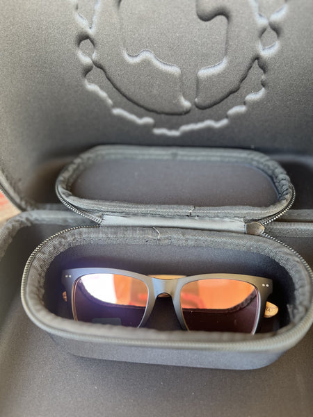 The Cactus Ally Hat Company Cap Carrier keeps your favorite caps protected and organized on the go. Designed in sleek black, it holds 4–5 caps securely and includes a built-in sunglasses case for added convenience. Carry it your way with both handheld and shoulder strap options—perfect for travel, rodeos, or everyday use. Available at BLAIR'S Western Wear located in Marble Falls, TX 