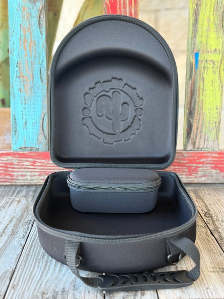 The Cactus Ally Hat Company Cap Carrier keeps your favorite caps protected and organized on the go. Designed in sleek black, it holds 4–5 caps securely and includes a built-in sunglasses case for added convenience. Carry it your way with both handheld and shoulder strap options—perfect for travel, rodeos, or everyday use. Available at BLAIR'S Western Wear located in Marble Falls, TX 