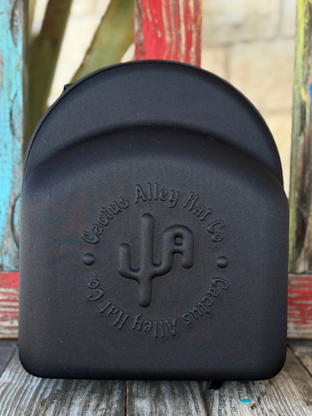 The Cactus Ally Hat Company Cap Carrier keeps your favorite caps protected and organized on the go. Designed in sleek black, it holds 4–5 caps securely and includes a built-in sunglasses case for added convenience. Carry it your way with both handheld and shoulder strap options—perfect for travel, rodeos, or everyday use. Available at BLAIR'S Western Wear located in Marble Falls, TX 