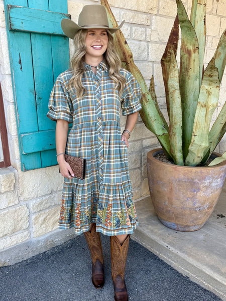 Women's blue, brown, and green plaid midi dress with puff sleeves, tiered skirt, and embroidered floral hem border — Blair's Western Wear Marble Falls TX