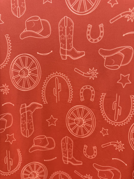 Close up of Girl's Long Sleeve Western Tee - CTK8990003 - this comfy orange shirt features such cute western graphics such as boots, horseshoes, cowgirl hats and many more! Available at Blair's Western Wear located in Marble Falls,TX. 