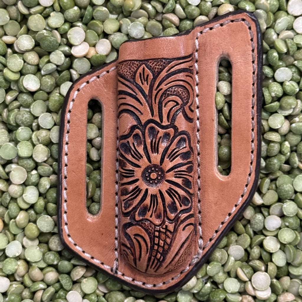 Hand-Tooled Leather Sheath in natural and black, crafted from durable leather with floral tooling on the front and dual belt slots for secure carry - XKS123. Available at Blair's Western Wear, Marble Falls, TX.