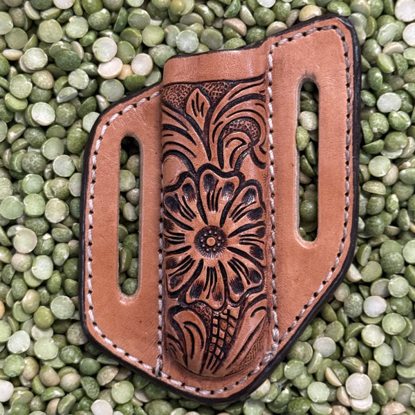 Hand-Tooled Leather Sheath in natural and black, crafted from durable leather with floral tooling on the front and dual belt slots for secure carry - XKS123. Available at Blair's Western Wear, Marble Falls, TX.