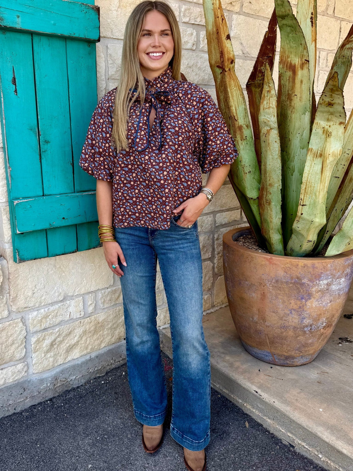 Women's medium wash Ariat Perfect Rise Trouser Jean styled with burgundy floral blouse and western boots, full outfit front view — Blair's Western Wear Marble Falls TX