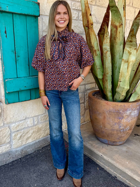 Women's medium wash Ariat Perfect Rise Trouser Jean styled with burgundy floral blouse and western boots, full outfit front view — Blair's Western Wear Marble Falls TX