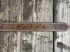A close-up of a brown leather belt end with 5 belt holes. Available at Blair's Western Wear, Marble Falls, TX
