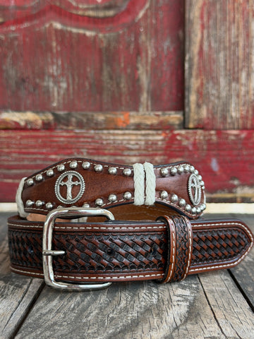 Dark brown basketweave-tooled leather is lined with silver domed studs and white braided lace trim, accented by rope-edged cross conchos —Available at BLAIR'S Western Wear located in Marble Falls TX 