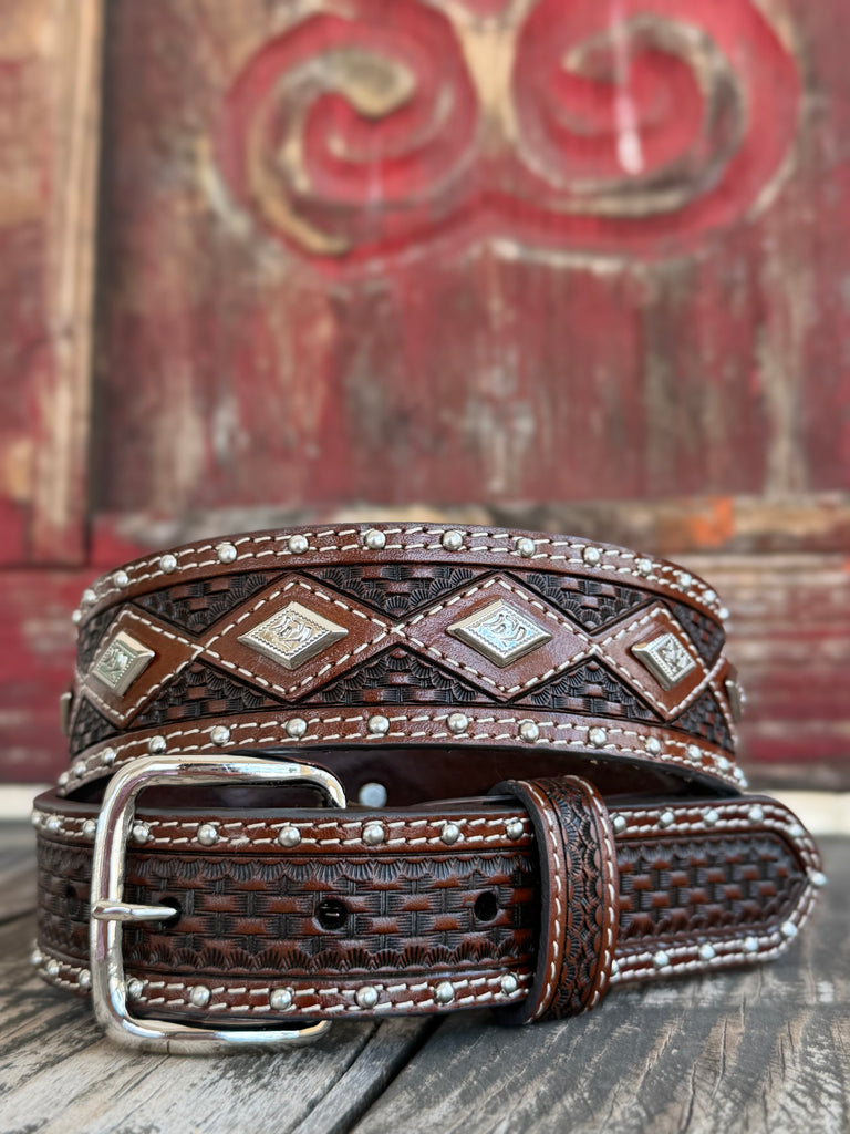 Dark brown basketweave-tooled leather is lined with silver studs and cream stitching, accented by engraved diamond conchos down the center — a richly detailed western belt with serious cowboy character. Available at BLAIR'S Western Wear located in Marble Falls TX 