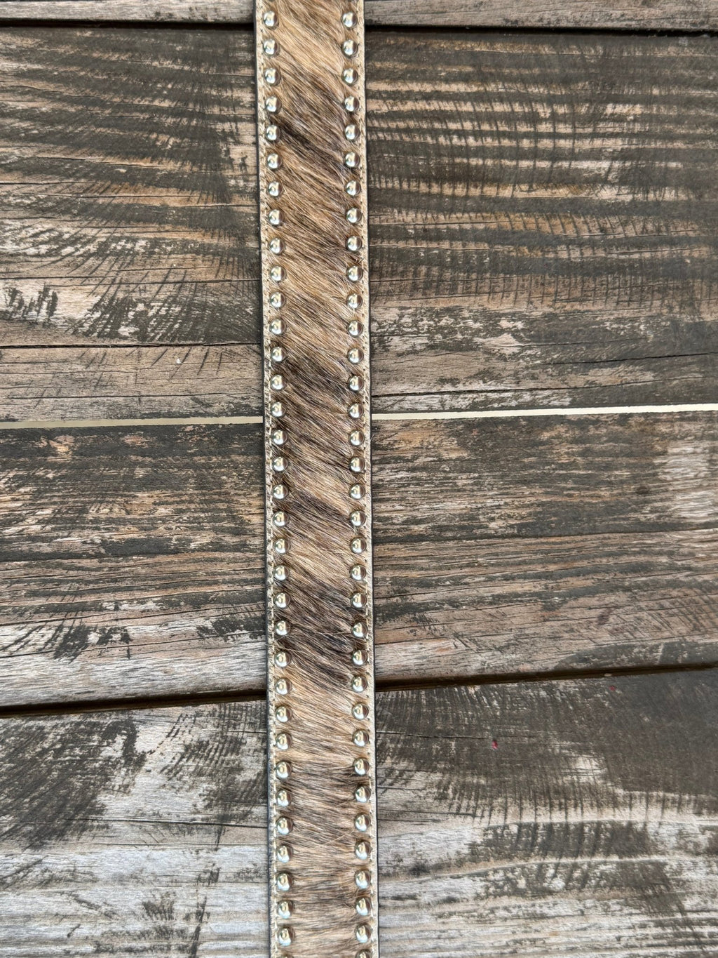 This belt features rich brown full-grain leather with a beautifully detailed basketweave tooling pattern, contrasting white stitching, silver star conchos and a polished silver buckle. The genuine hair-on hide leather accent adds natural texture and character, making each belt one of a kind with its own unique color variations and markings.
Available at Blair's Western Wear located in Marble Falls TX 