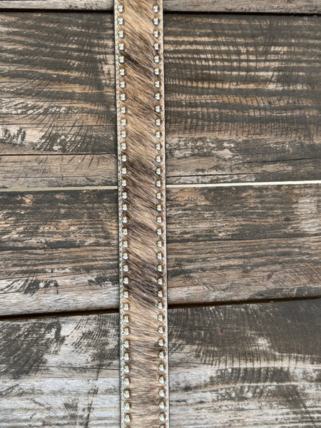 This belt features rich brown full-grain leather with a beautifully detailed basketweave tooling pattern, contrasting white stitching, silver star conchos and a polished silver buckle. The genuine hair-on hide leather accent adds natural texture and character, making each belt one of a kind with its own unique color variations and markings.
Available at Blair's Western Wear located in Marble Falls TX 