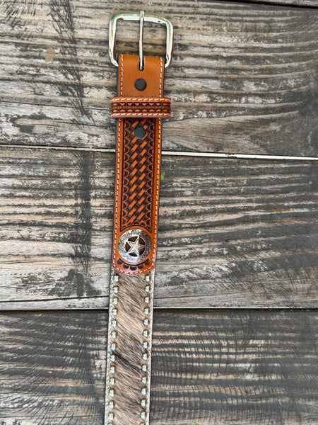 This belt features rich brown full-grain leather with a beautifully detailed basketweave tooling pattern, contrasting white stitching, silver star conchos and a polished silver buckle. The genuine hair-on hide leather accent adds natural texture and character, making each belt one of a kind with its own unique color variations and markings.
Available at Blair's Western Wear located in Marble Falls TX 