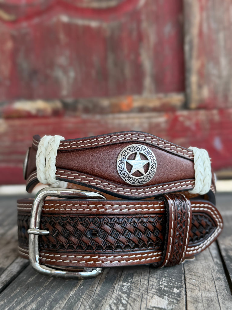 Rich brown basketweave-tooled leather is accented with scalloped edges, white laced trim, and engraved Texas star conchos — a classic Lone Star statement belt with serious western craftsmanship. Available at BLAIRS Western Wear located in Marble Falls TX 