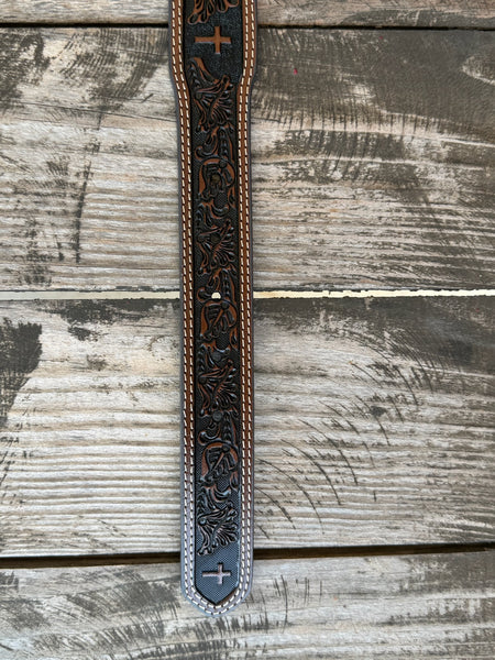 Leather Western belt featuring a hand-tooled floral pattern with a textured black background and a centered cross design. Finished with double white contrast stitching, matching leather keeper, and a polished silver roller buckle. Built for everyday wear with durable leather construction and classic Western craftsmanship.

Available at Blairs' Western Wear, located in Marble Falls.