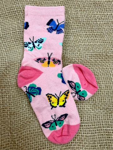Kids' Socksmith Butterfly Migration crew socks in pink, made with a soft cotton blend for comfort, reinforced heel and toe for durability, and playful multicolor butterfly design - KC1064. Available at Blair's Western Wear, Marble Falls, TX.
