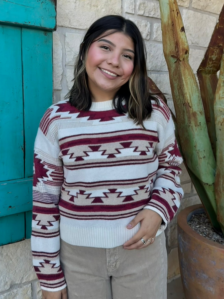 This Ariat Aztec Sweater blends cozy warmth with bold southwestern style. Featuring a soft knit fabric, rich wine-and-tan Aztec pattern, and classic crew neckline, it’s the perfect throw-on piece for cool days and effortless western flair. Available at BLAIR'S Western Wear located in Marble Falls TX. 