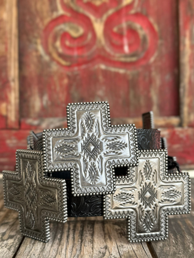 Black genuine leather belt with deep floral tooling and oversized cross-shaped silver conchos featuring Aztec-inspired engraving, a beaded rope border, and a diamond center stone. A bold western statement piece for any occasion.

Available at Blair's Western Wear, Marble Falls, TX