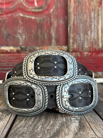 Black leather belt with subtle scroll embossing and scattered silver stud accents along the strap, finished with a large oval silver concho buckle set featuring rope-edge border, scroll engraving, and a matching concho keeper. Sleek, bold, and unmistakably Western. Shop at Blair's Western Wear — blairswesternwear.com.