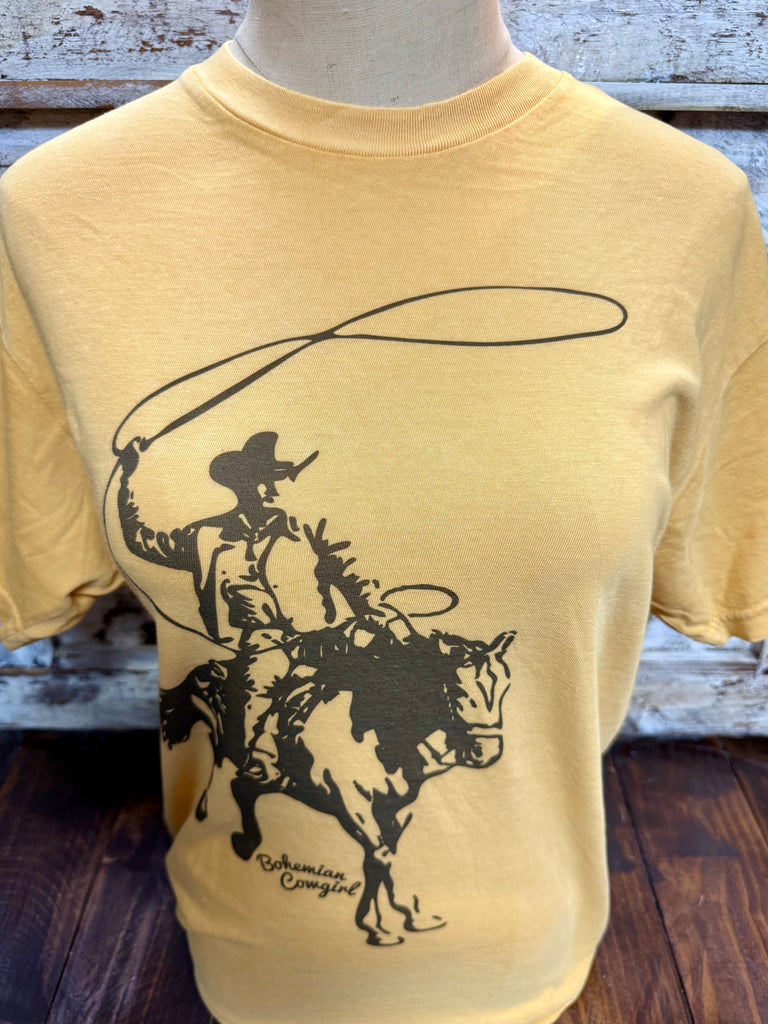 Ladies Bohemian Cowgirl short sleeve graphic tee ropin cowboy in mustard, soft cotton-blend fabric for all-day comfort, with a bold western roping cowboy graphic - CBHRPE. Available at Blair's Western Wear, Marble Falls, TX.