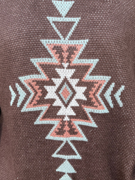 Ladies Aztec Sweater crafted in a warm brown knit, featuring a bold Aztec design in mint and natural tones along with soft fringe detailing down the sleeves. Its relaxed fit and textured finish make it perfect for pairing with your favorite denim or cords, all while keeping you stylish and comfortable through the cooler seasons. Available at BLAIR'S Western Wear located in Marble Falls TX.
