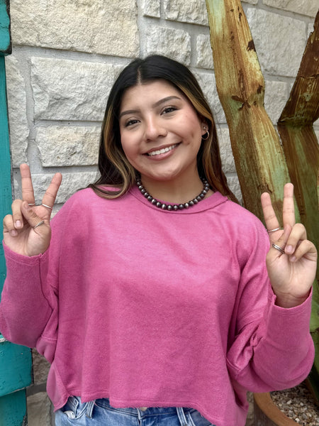 Ladies cropped knit sweater top in bright pink, featuring breathable knit fabric and a relaxed cropped fit with long sleeves and drop shoulders – HF25C775. Available at Blair's Western Wear, Marble Falls, TX.