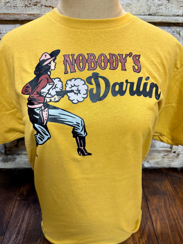 Ladies Emily Laurence short sleeve graphic tee Nobody’s Darlin in mustard, soft breathable cotton-blend fabric for all-day comfort, with retro cowgirl Western graphic for bold casual style – NOBODY’S. Available at Blair's Western Wear, Marble Falls, TX.
