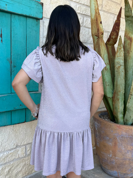 This shimmery lavender Ivy Jane dress brings easy feminine charm with its flutter sleeves, soft knit fabric, and flouncy ruffle hem. Perfect for everyday wear or a dressed-up look, it’s a comfortable standout piece for any wardrobe. Available at BLAIR’S Western Wear located in Marble Falls, TX.