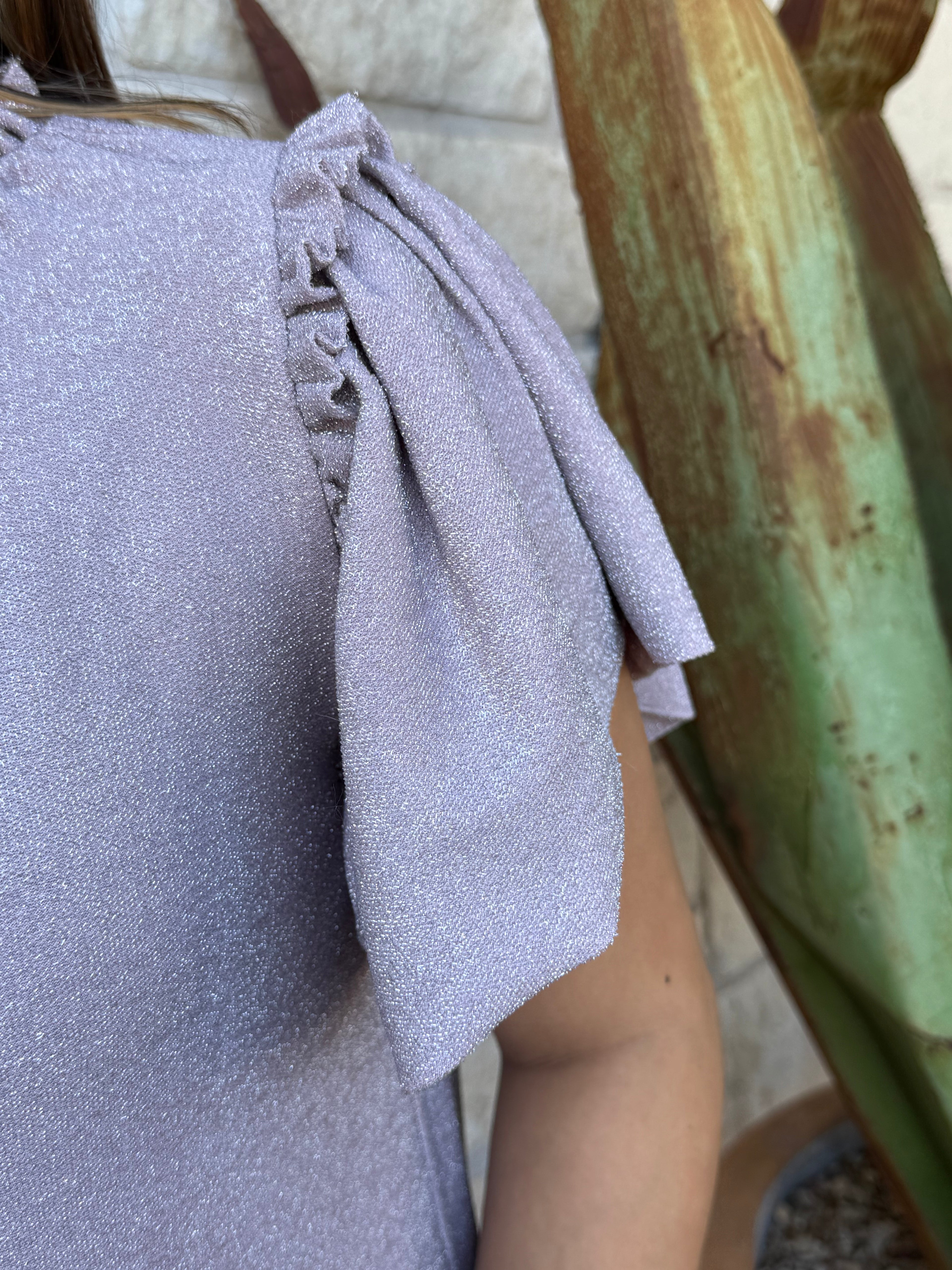 This shimmery lavender Ivy Jane dress brings easy feminine charm with its flutter sleeves, soft knit fabric, and flouncy ruffle hem. Perfect for everyday wear or a dressed-up look, it’s a comfortable standout piece for any wardrobe. Available at BLAIR’S Western Wear located in Marble Falls, TX.