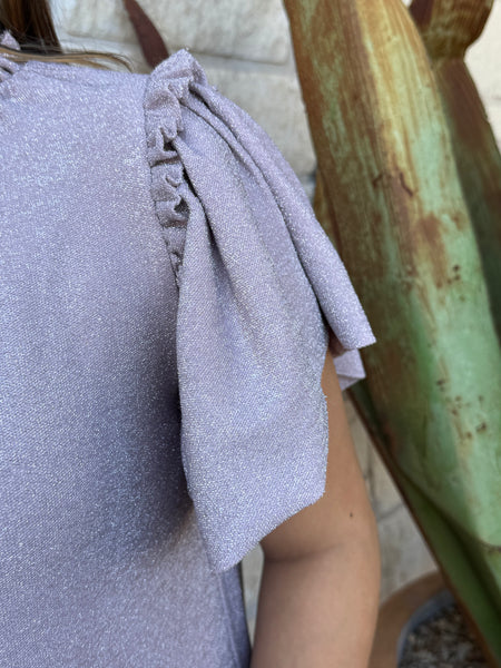 This shimmery lavender Ivy Jane dress brings easy feminine charm with its flutter sleeves, soft knit fabric, and flouncy ruffle hem. Perfect for everyday wear or a dressed-up look, it’s a comfortable standout piece for any wardrobe. Available at BLAIR’S Western Wear located in Marble Falls, TX.