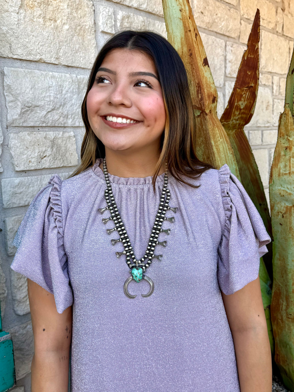 This shimmery lavender Ivy Jane dress brings easy feminine charm with its flutter sleeves, soft knit fabric, and flouncy ruffle hem. Perfect for everyday wear or a dressed-up look, it’s a comfortable standout piece for any wardrobe. Available at BLAIR’S Western Wear located in Marble Falls, TX.
