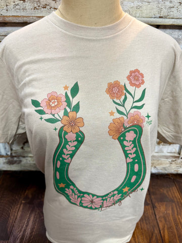 Ladies Lucky You short sleeve graphic tee in tan, floral horseshoe design for western-inspired style, with lightweight breathable fabric for everyday comfort - LUCKYU. Available at Blair's Western Wear, Marble Falls, TX.