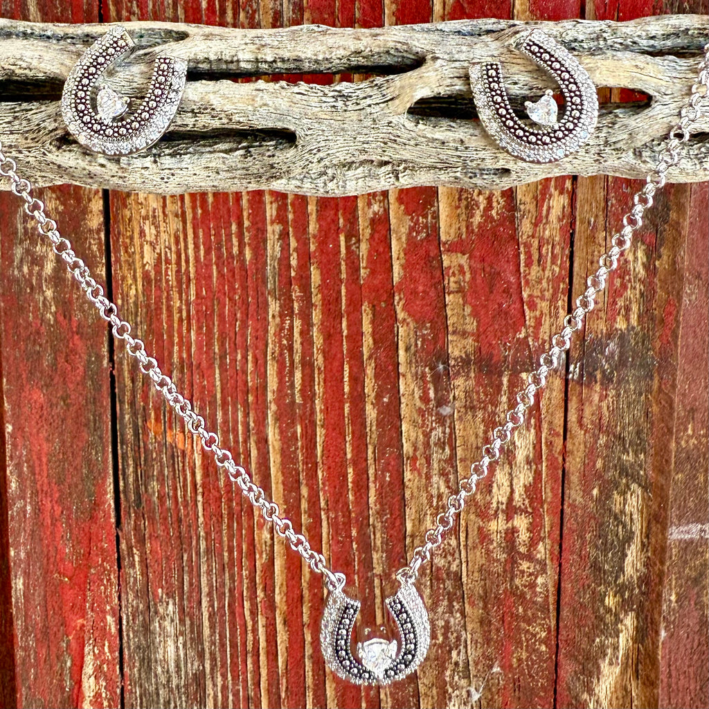 Ladies Montana Silversmiths jewelry set with silver horseshoe necklace and earrings, featuring clear cubic zirconia stones and antique silver finish for elegant western style - JS6307. Available at Blair's Western Wear, Marble Falls, TX.