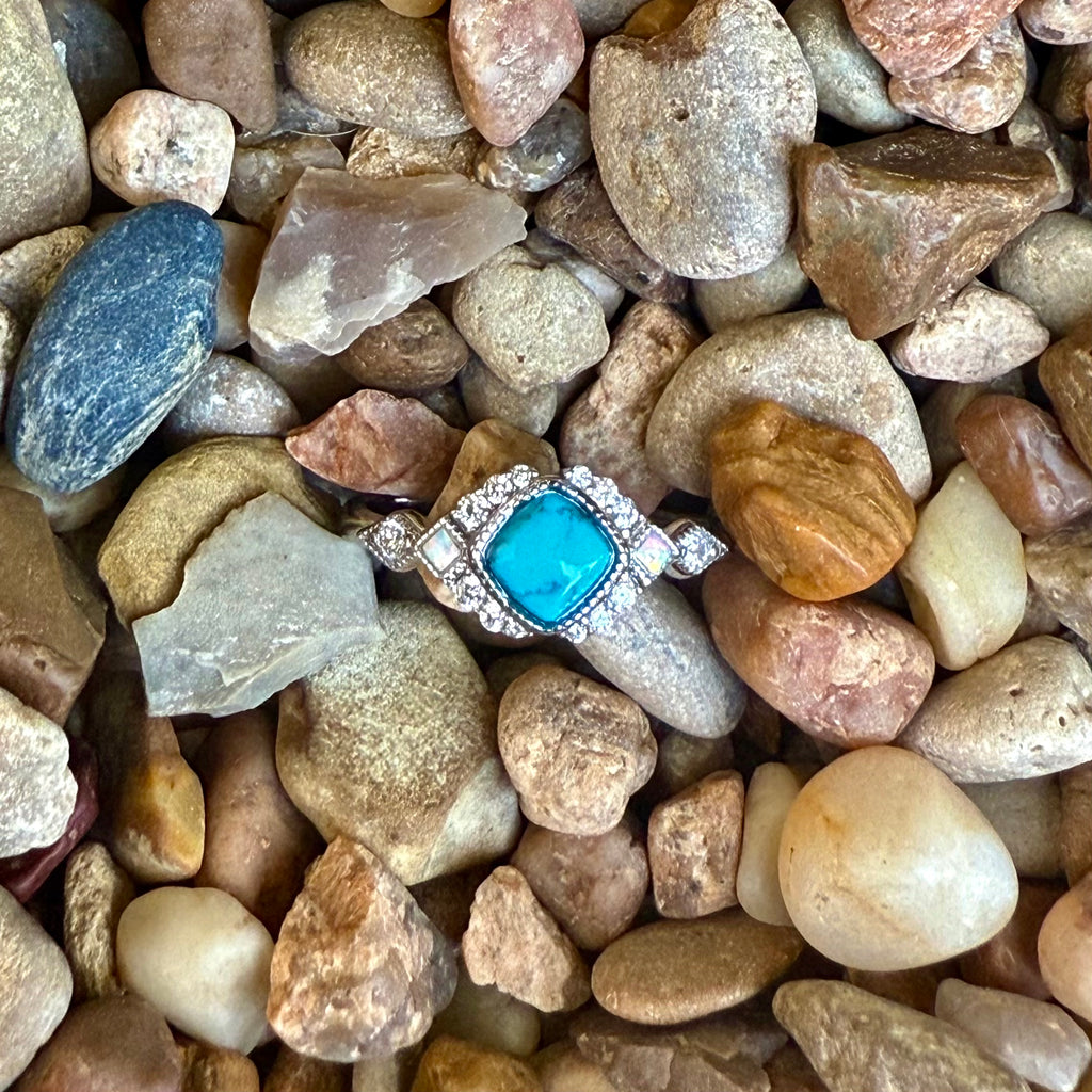 Ladies Montana Silversmiths ring with turquoise Crown Glacier stone in silver, featuring a radiant turquoise center framed by crystals, with rhodium-plated band for lasting shine - RG6313. Available at Blair's Western Wear, Marble Falls, TX.