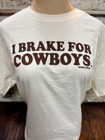 Ladies Rodeo Hippie short sleeve graphic tee in natural, soft cotton-blend fabric for all-day comfort, with bold “I Brake for Cowboys” brown graphic and relaxed ladies’ fit – BRAKES. Available at Blair's Western Wear, Marble Falls, TX.