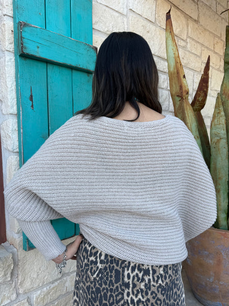 This sweater in Natural is the perfect blend of comfort and effortless style. Made with a soft, textured knit, it features a relaxed drop-shoulder fit paired with long, ribbed sleeves for a cozy yet polished look. Its neutral shade makes it easy to pair with anything—from denim to printed skirts—while the lightweight feel keeps it comfortable for all-day wear. Simple, timeless, and effortlessly chic. Available at BLAIR'S Western Wear located in Marble Falls TX.