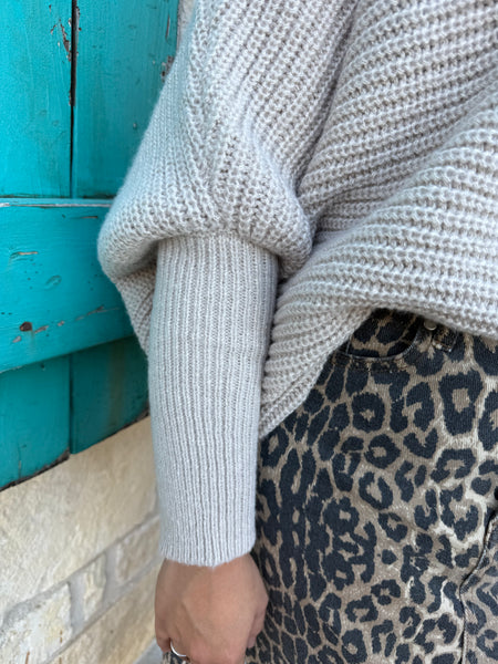 This sweater in Natural is the perfect blend of comfort and effortless style. Made with a soft, textured knit, it features a relaxed drop-shoulder fit paired with long, ribbed sleeves for a cozy yet polished look. Its neutral shade makes it easy to pair with anything—from denim to printed skirts—while the lightweight feel keeps it comfortable for all-day wear. Simple, timeless, and effortlessly chic. Available at BLAIR'S Western Wear located in Marble Falls TX.

