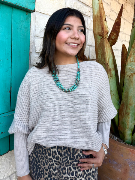 This sweater in Natural is the perfect blend of comfort and effortless style. Made with a soft, textured knit, it features a relaxed drop-shoulder fit paired with long, ribbed sleeves for a cozy yet polished look. Its neutral shade makes it easy to pair with anything—from denim to printed skirts—while the lightweight feel keeps it comfortable for all-day wear. Simple, timeless, and effortlessly chic. Available at BLAIR'S Western Wear located in Marble Falls TX.