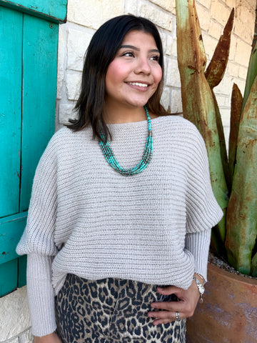 This sweater in Natural is the perfect blend of comfort and effortless style. Made with a soft, textured knit, it features a relaxed drop-shoulder fit paired with long, ribbed sleeves for a cozy yet polished look. Its neutral shade makes it easy to pair with anything—from denim to printed skirts—while the lightweight feel keeps it comfortable for all-day wear. Simple, timeless, and effortlessly chic. Available at BLAIR'S Western Wear located in Marble Falls TX.