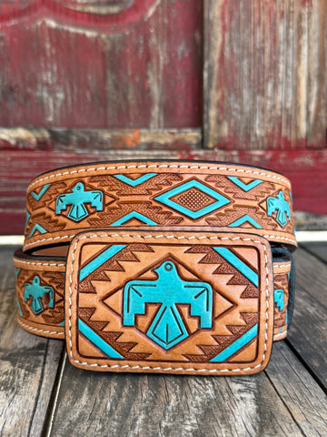 Rich tan tooled leather meets a painted turquoise Aztec-inspired bird design; — a bold, color-forward western belt with deep southwestern character that turns heads from across the room. The intricate tooling and vivid turquoise tones bring a heritage-inspired artistry to everyday western style, making this belt as much a statement piece as it is a wardrobe staple.