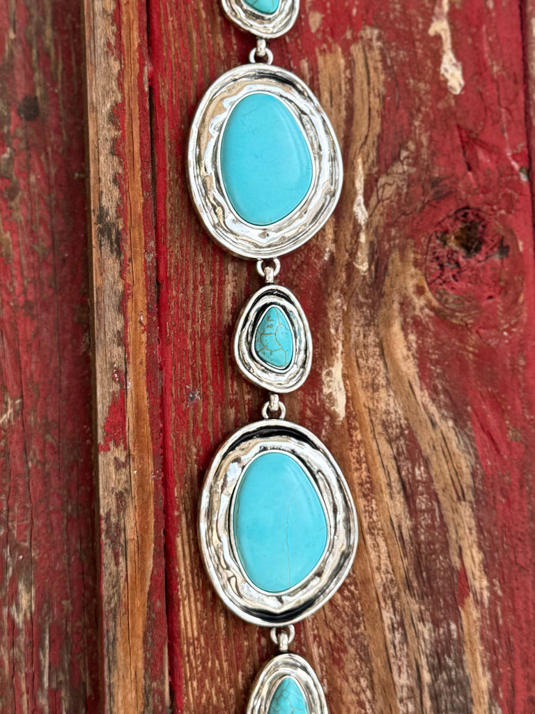 Alternating large oval and small teardrop turquoise-stone cabochons set in hammered silver frames, linked together by a delicate silver chain — this belt is pure Southwestern soul. Bold enough to be the centerpiece of any outfit, yet refined enough to wear anywhere the occasion calls for a little western elegance. Available at Blair's Western Wear 