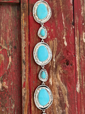 Alternating large oval and small teardrop turquoise-stone cabochons set in hammered silver frames, linked together by a delicate silver chain — this belt is pure Southwestern soul. Bold enough to be the centerpiece of any outfit, yet refined enough to wear anywhere the occasion calls for a little western elegance. Available at Blair's Western Wear 