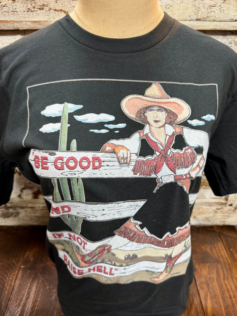 Ladies XOXO short sleeve graphic tee in black and white, soft lightweight fabric for all-day comfort, with a vintage Western cowgirl graphic and bold “Be Good” message – BE GOOD. Available at Blair's Western Wear, Marble Falls, TX.