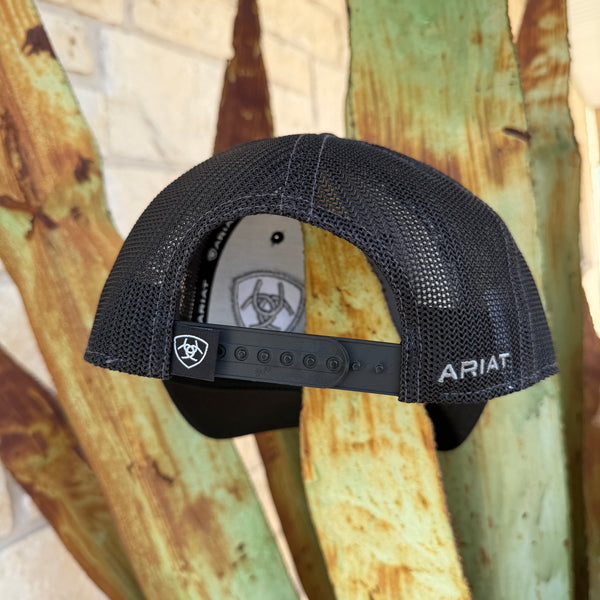 Black mesh trucker cap with adjustable snapback closure, featuring the ARIAT logo on the side 