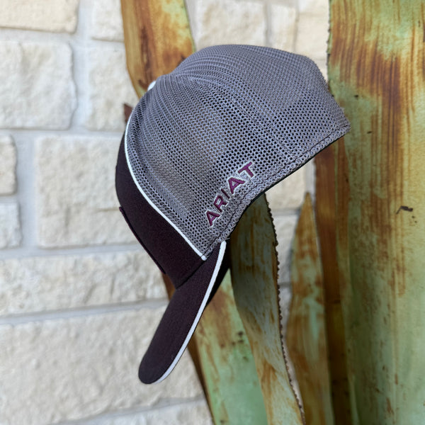 A gray and dark burgundy trucker-style cap with a mesh back and a dark visor, The word 'ARIAT' is embroidered in burgundy on the side 
