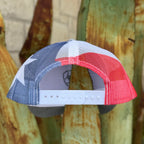 A trucker-style baseball cap with a red, white, and blue Texas flag-inspired pattern on the back mesh 