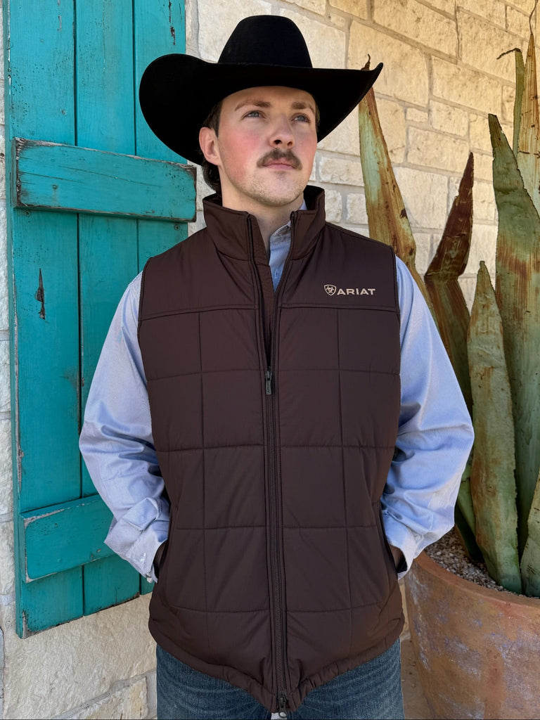 Men’s Ariat quilted insulated vest in brown, built with a water-repellent ripstop shell and Cool Climate™ insulation, featuring a concealed carry pocket and full-zip front – 10062603. Available at Blair’s Western Wear, Marble Falls, TX.