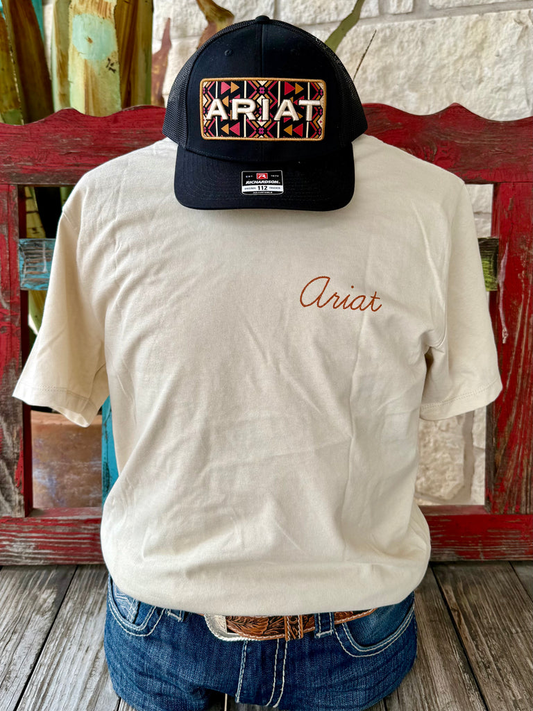 Men’s Ariat short sleeve logo tee in natural/rust, built with soft breathable cotton, featuring a bold back roper graphic for a classic Western look – 10065893. Available at Blair's Western Wear, Marble Falls, TX.
