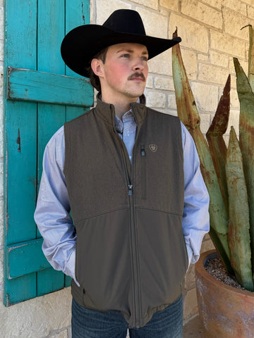 Men’s Ariat softshell vest in olive, featuring wind- and water-resistant fabric, flexible microfleece lining, and secure zippered pockets – 10062591. Available at Blair’s Western Wear, Marble Falls, TX.